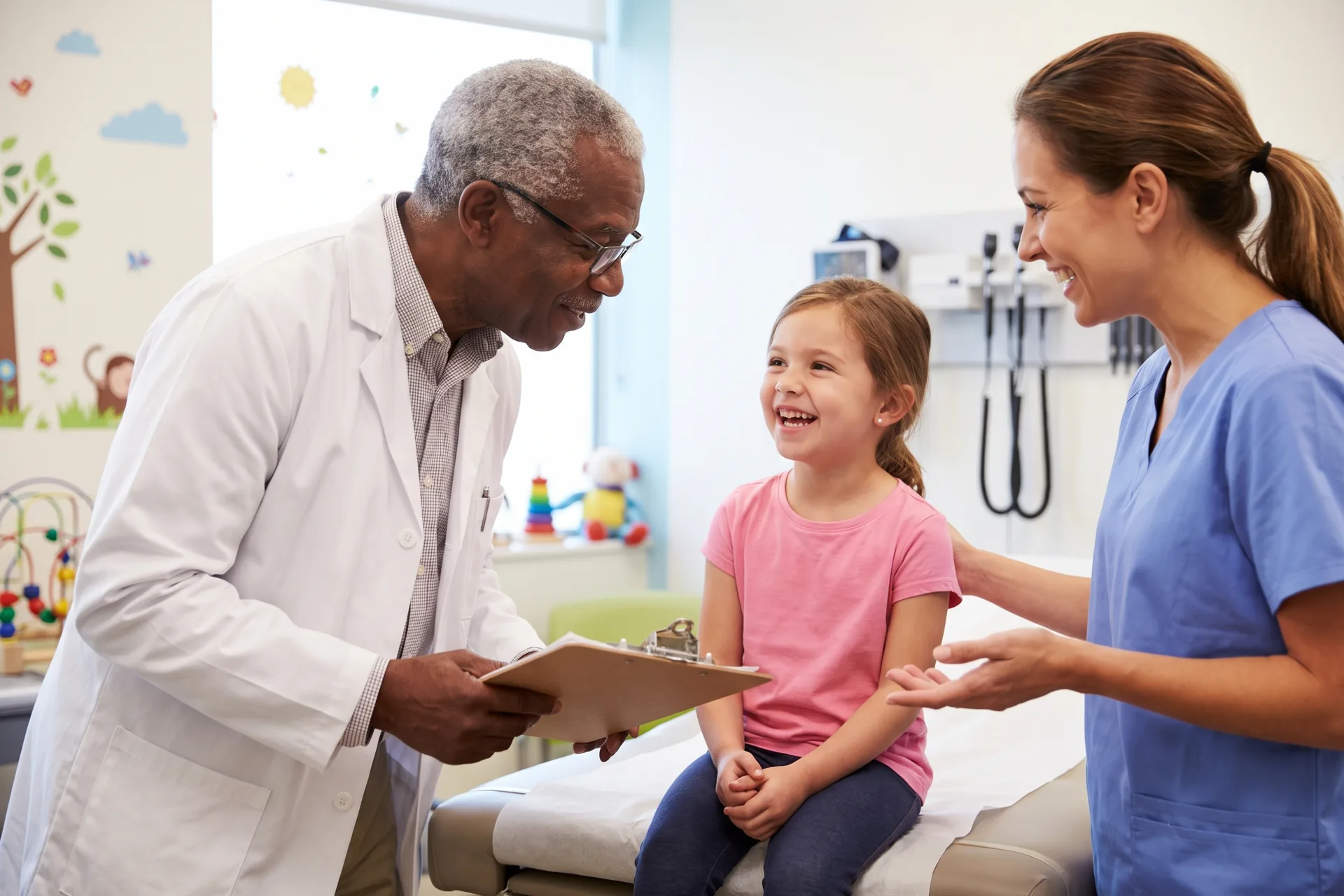 Doctor and nurse performing an annual check-up on a child